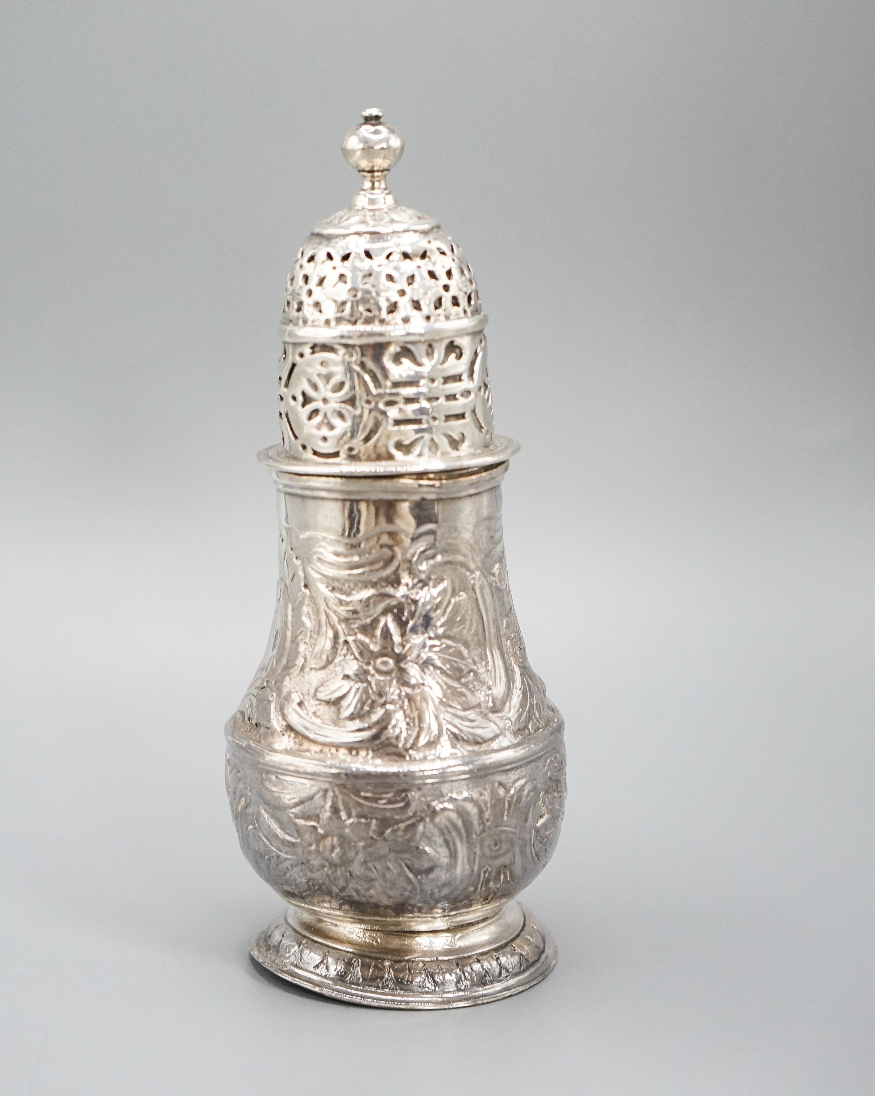 A George I silver sugar caster, with later? embossed decoration, Charles Adam, London, 1716, 13.5cm, 4.5oz.